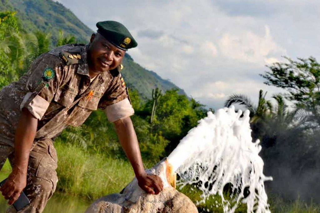 a national park ranger at a hotspring in semuliki - kwezi outdoors
